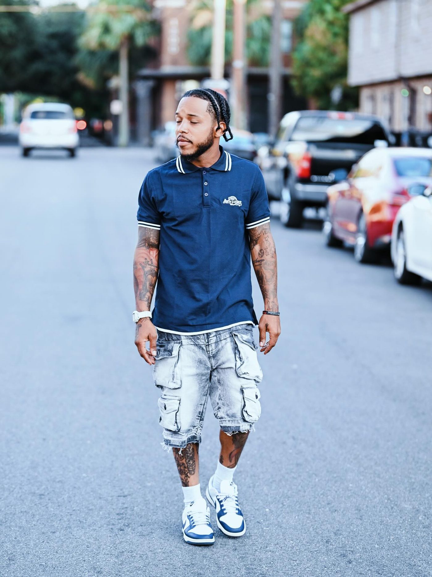 Navy Lone Wolves polo worn with cargo shorts on a New Orleans street